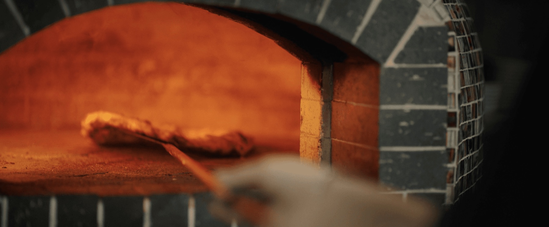 The fire-lit pizza oven from Blood, Sweat & Dough